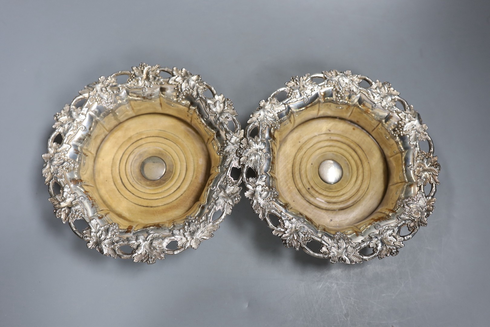 A pair of Victorian Sheffield plate wine coasters and plated comport, 13 cms high.